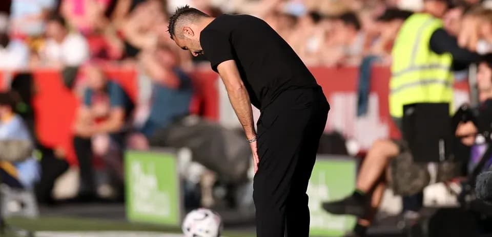 Coach observing the game with focused posture