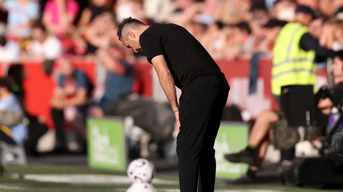 Coach observing the game with focused posture