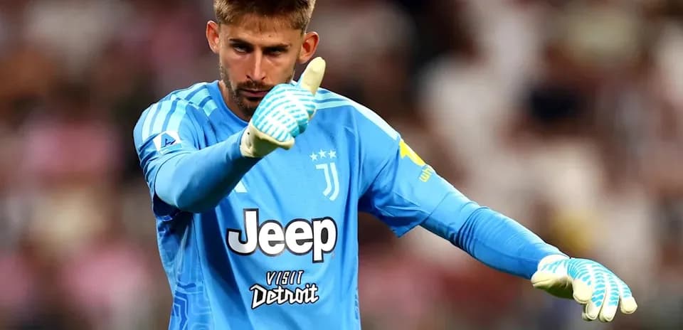 Goalkeeper in Juventus kit signaling during match