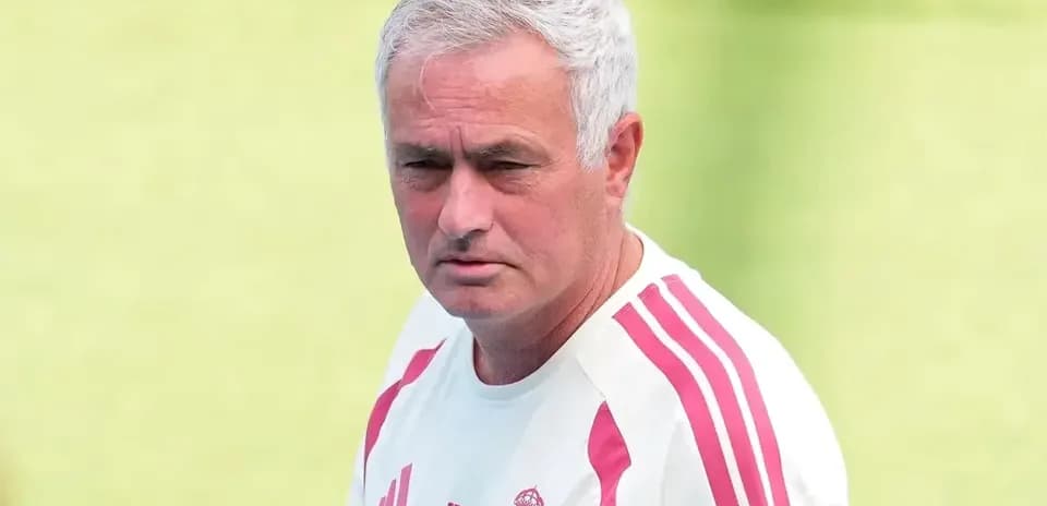 Football coach observing training session on field
