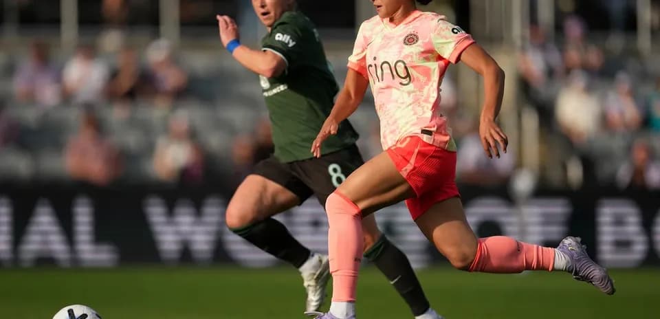Two players competing for the ball in match