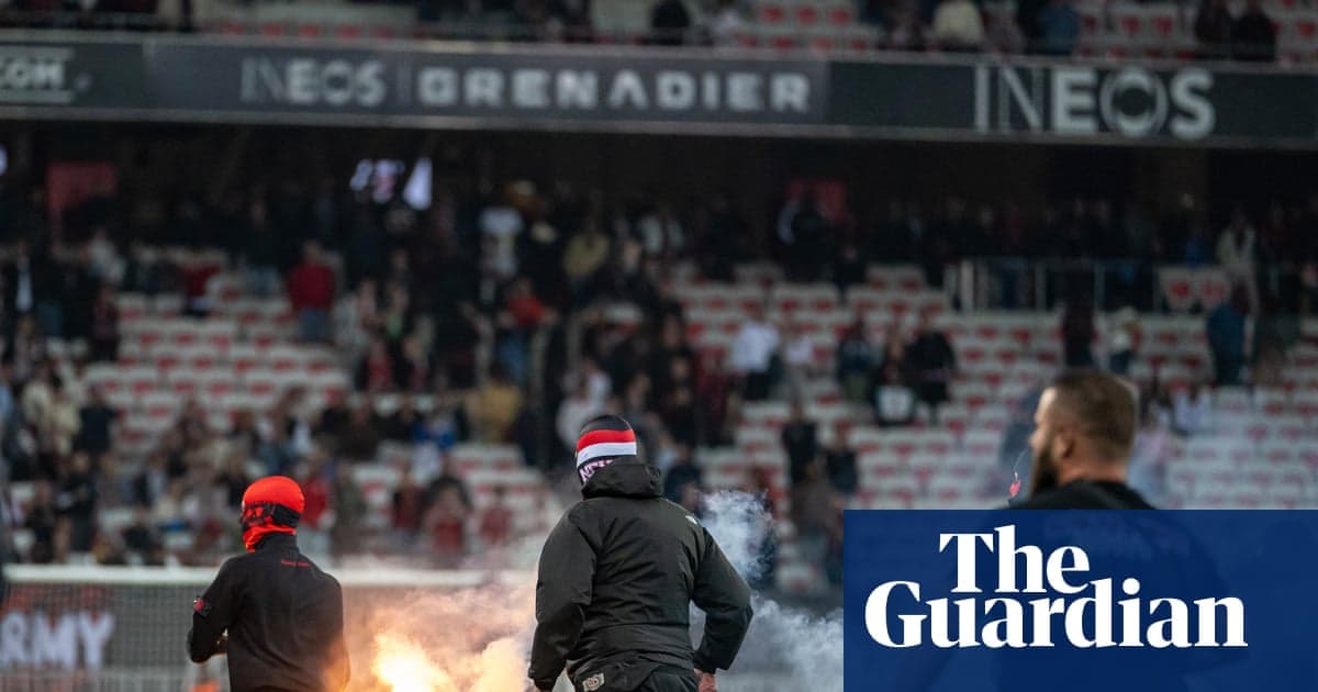 Fans igniting flares during a football match