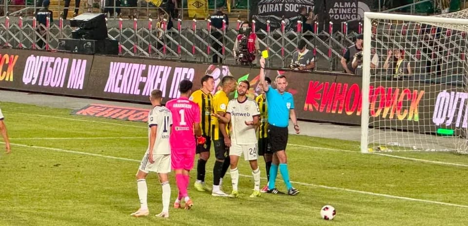 Players discussing with referee during Kairat match