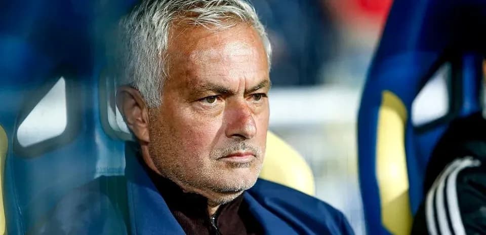Coach seated on bench during a match