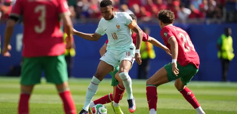 Player from France dribbling past Moroccan defenders