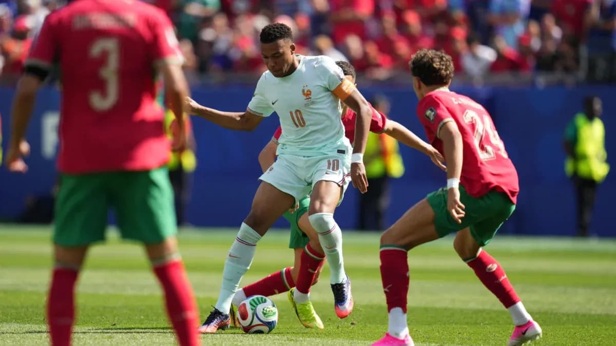 Player from France dribbling past Moroccan defenders