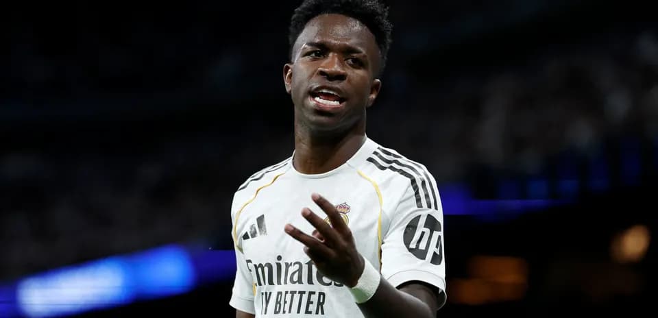Player gesturing during match in white jersey