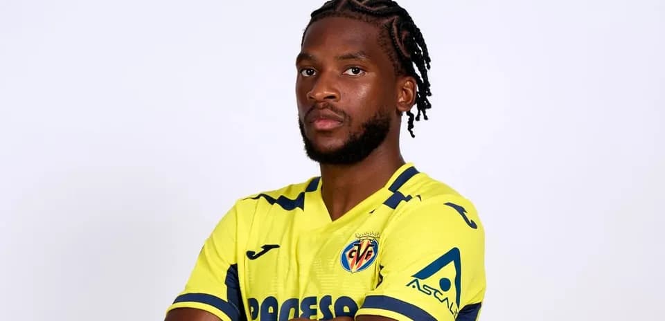 Player posing in Villarreal yellow jersey
