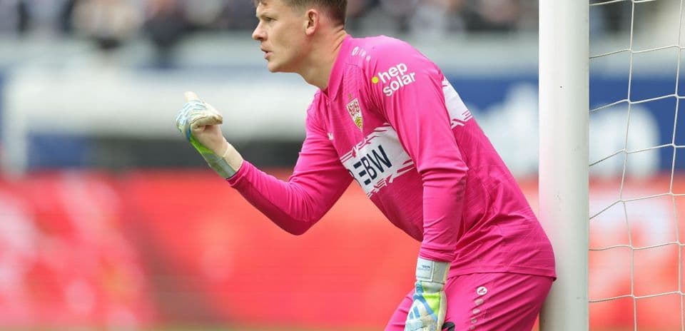 Goalkeeper in pink kit signaling during match
