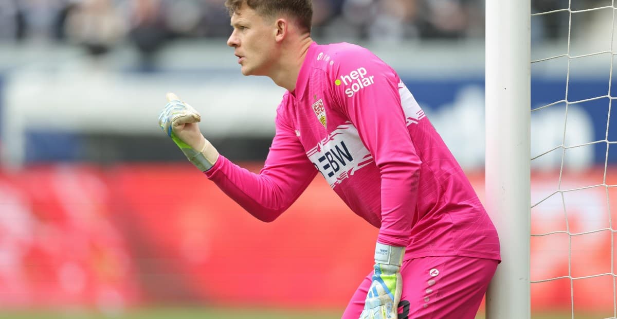 Goalkeeper in pink kit signaling during match