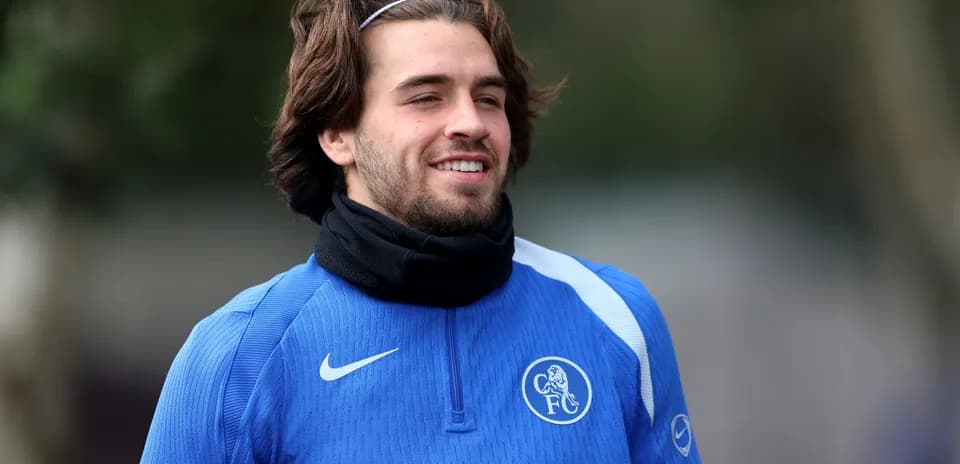 Player in blue training kit smiling during practice