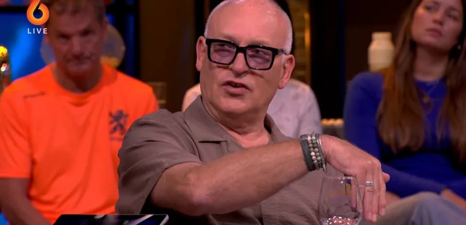 Man speaking during a talk show with guests
