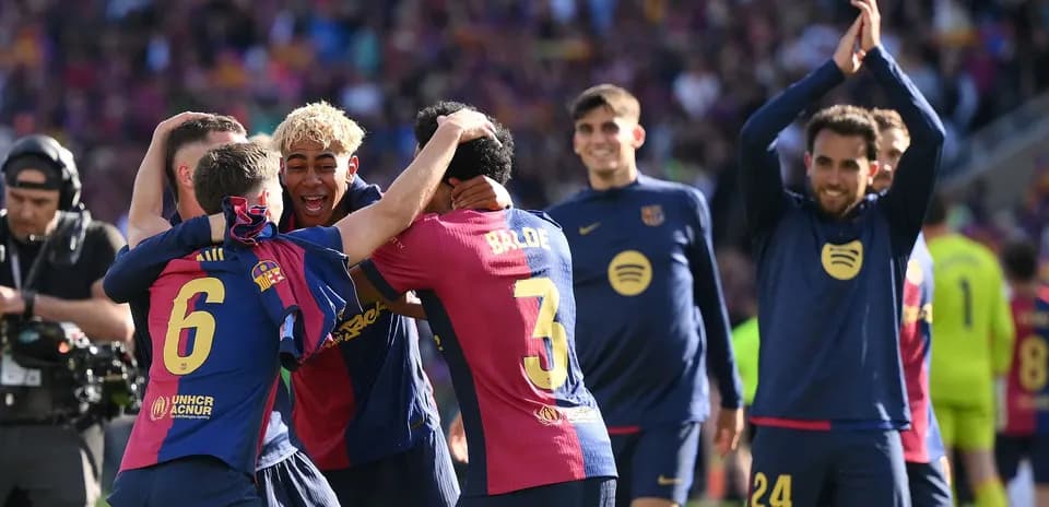 Barcelona players celebrating a victory on the pitch