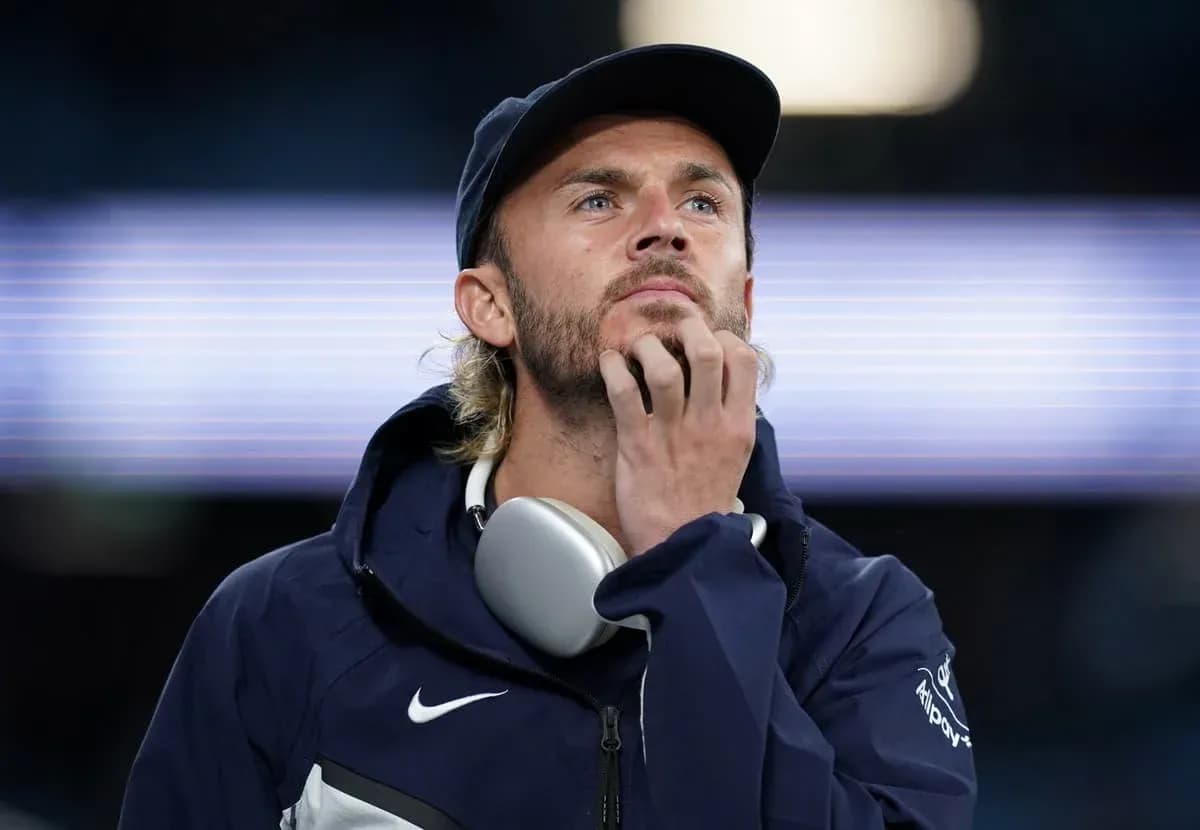 Man with headphones contemplating at stadium