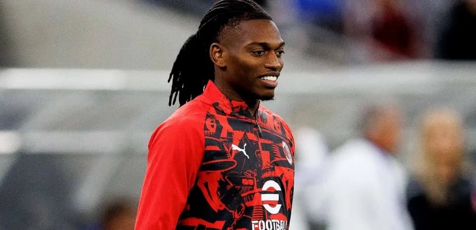 Player wearing red training jacket on the field