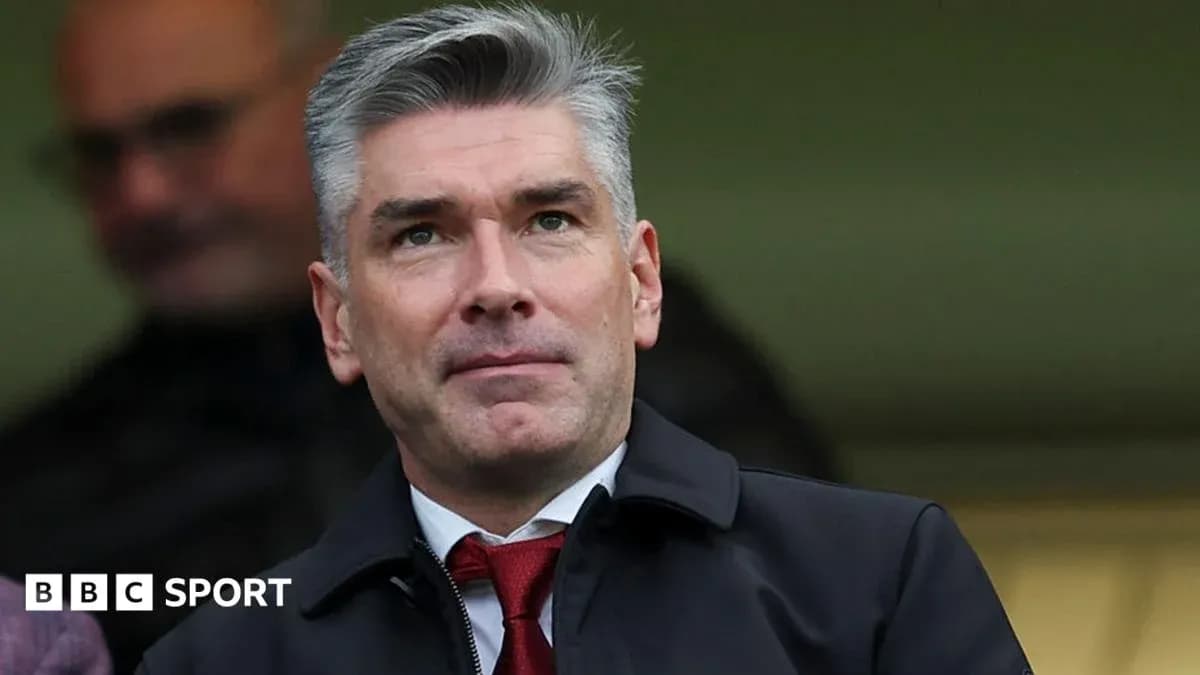 Man in suit observing from a stadium box