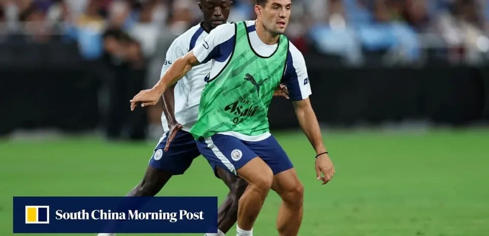 Two players training on the pitch in practice vests