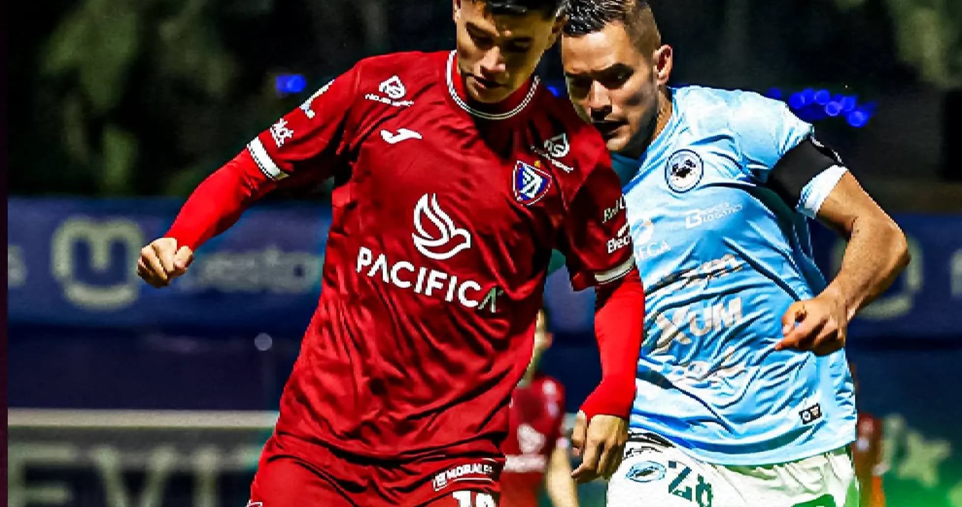 Two players competing for the ball in football match