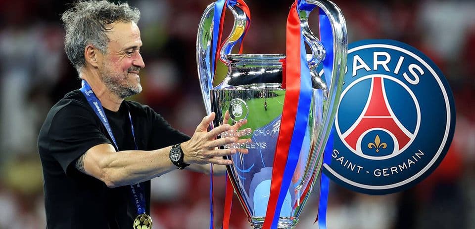 Coach holding UEFA Champions League trophy with PSG logo