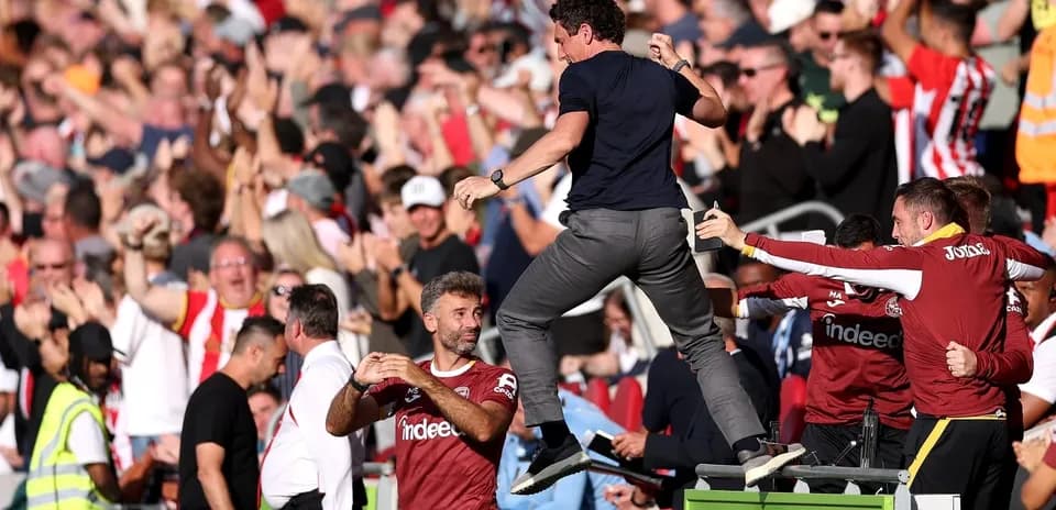 Coach celebrating with fans during a match