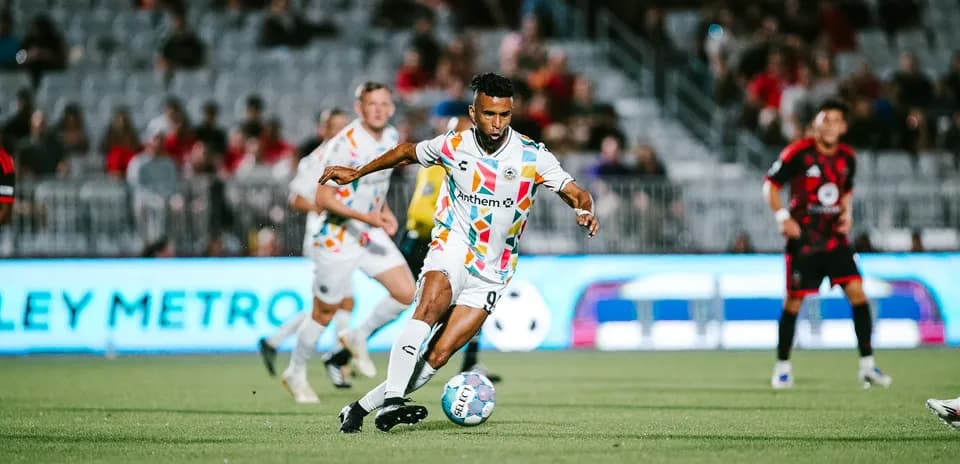 Player dribbling the ball during Phoenix Rising match