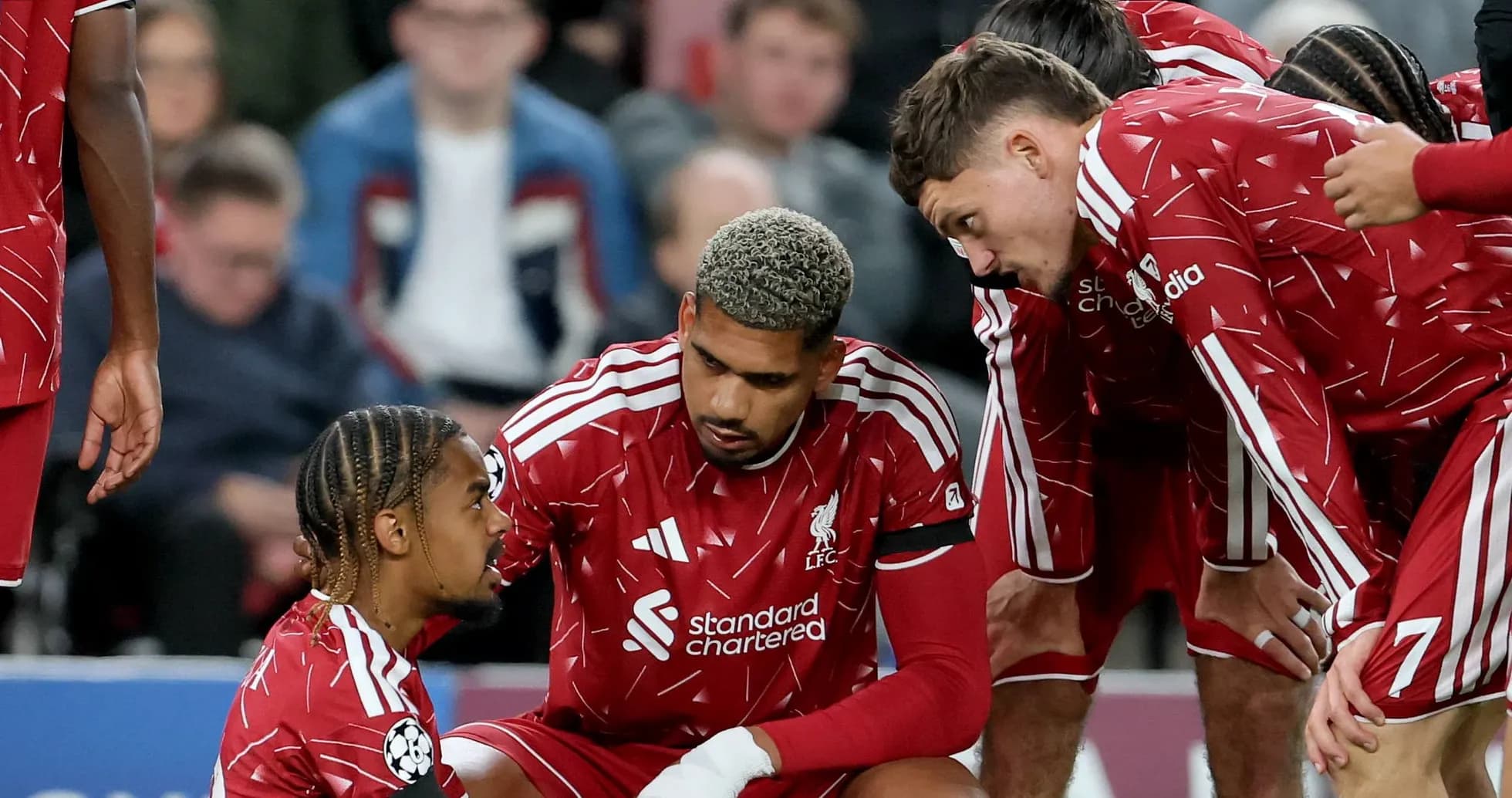 Liverpool players discussing strategy during match break