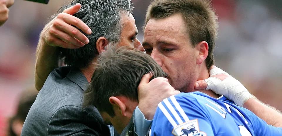 Players and manager embracing after match conclusion