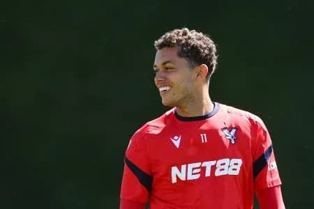 Player smiling during training session in red kit