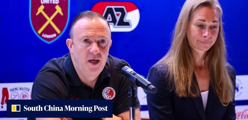 Man speaking at press conference with woman beside