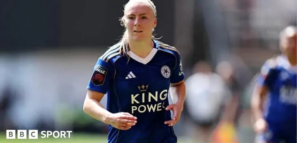 Player in blue jersey running on the pitch