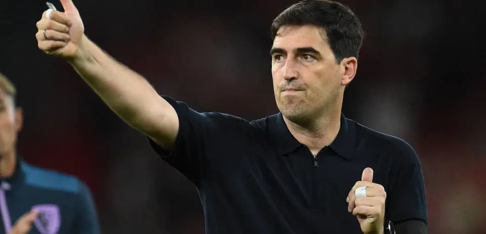 Coach giving a thumbs-up gesture on the field