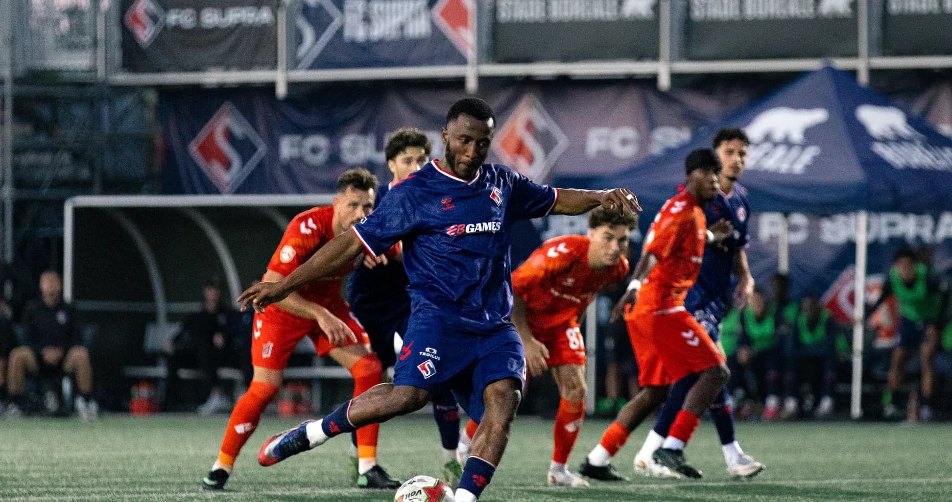 Player kicking the ball during match