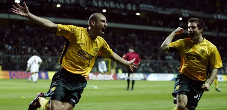 Two players celebrating a goal on the field