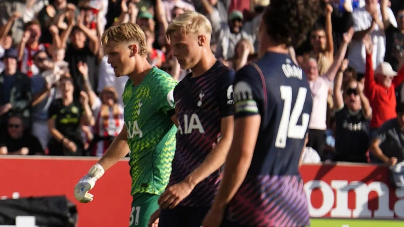 Tottenham players walking past cheering fans