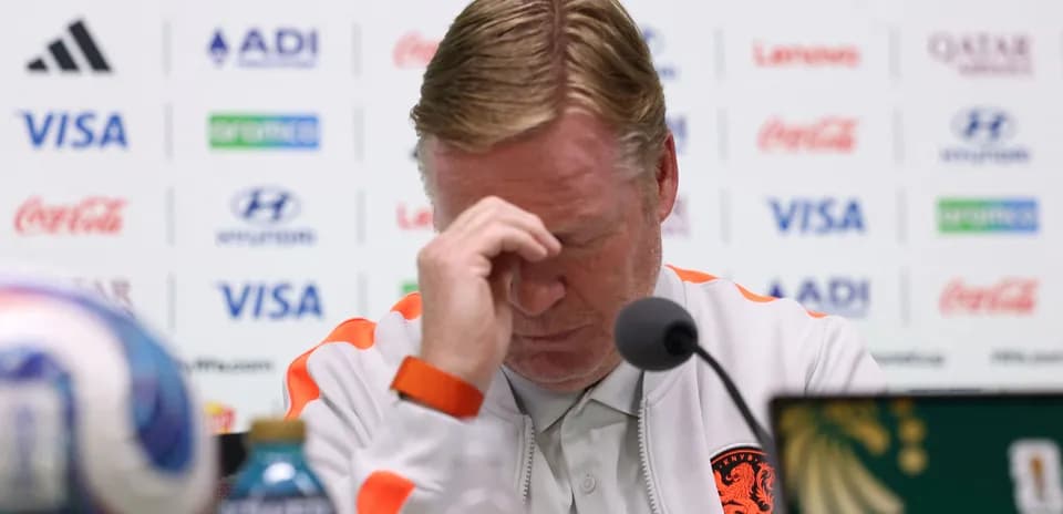 Manager at press conference with hand on forehead