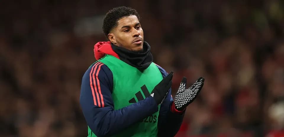 Player applauding while wearing training gear on sidelines