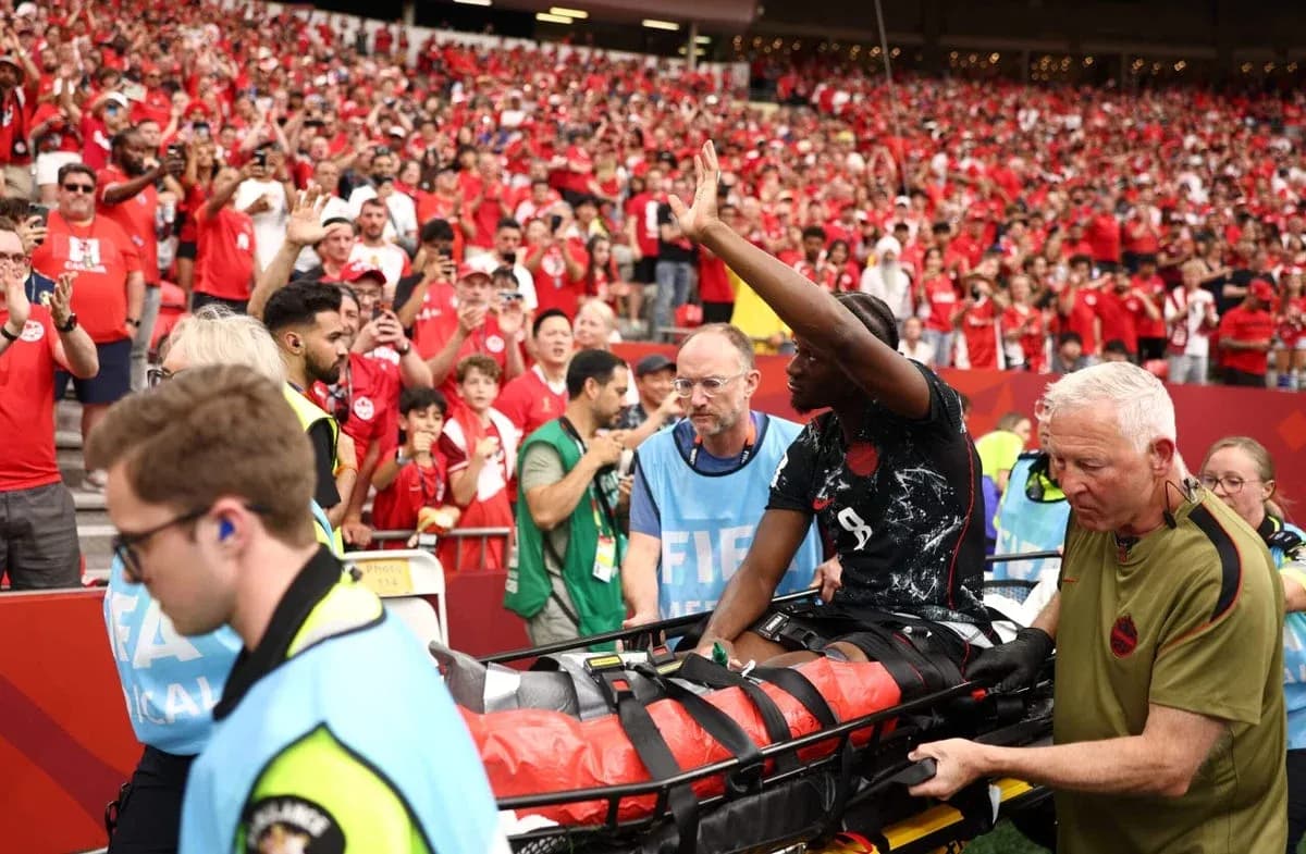 Player being carried off on stretcher by medical staff