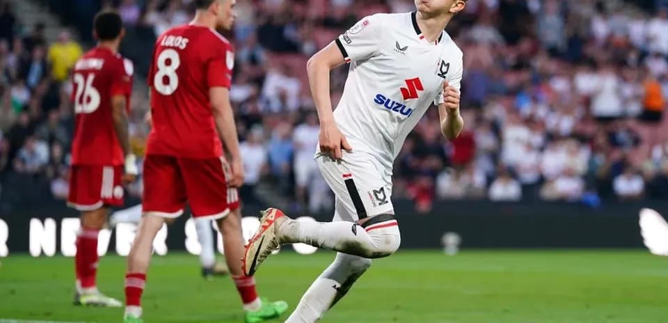 MK Dons player celebrating after scoring goal