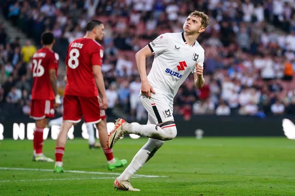 MK Dons player celebrating after scoring goal