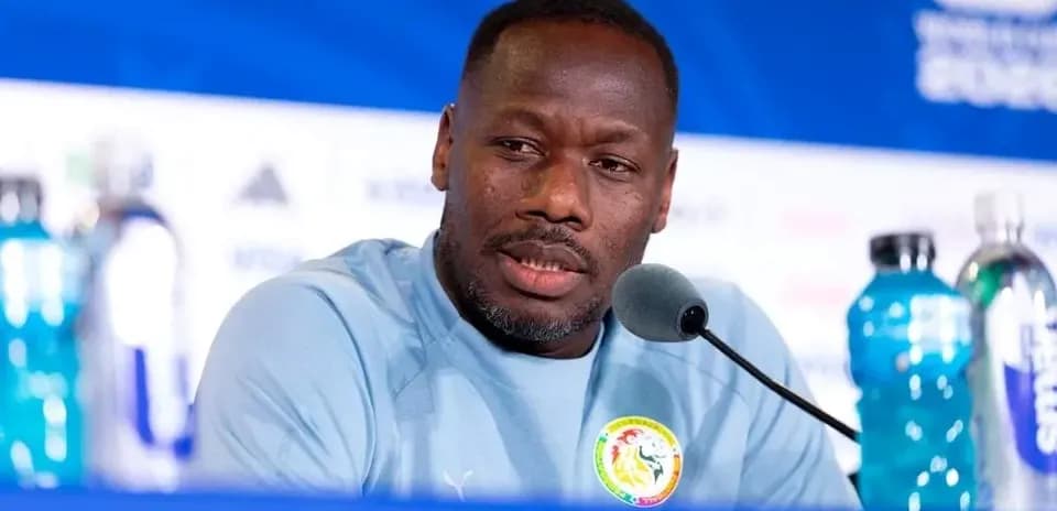 Manager speaking at press conference with water bottles