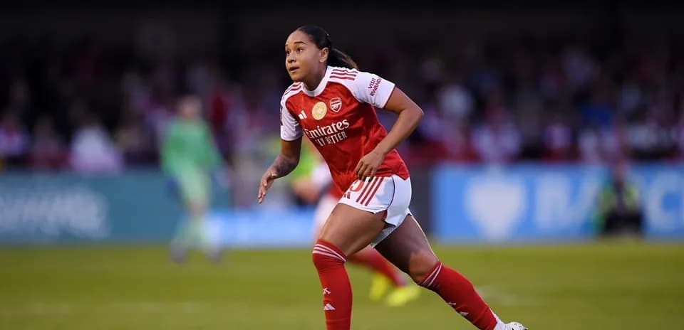 Player in Arsenal kit running on the field