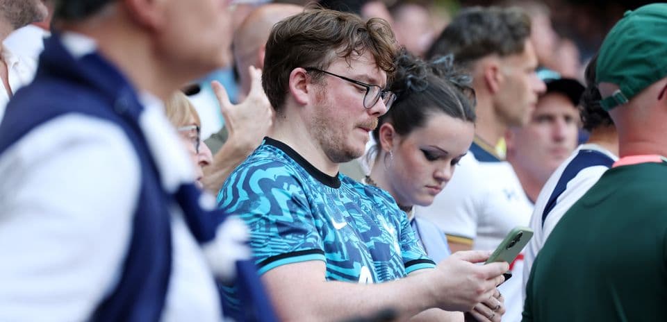Fans focused on their phones during the event