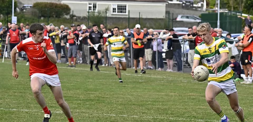 Player in green and yellow shirt receiving ball on field