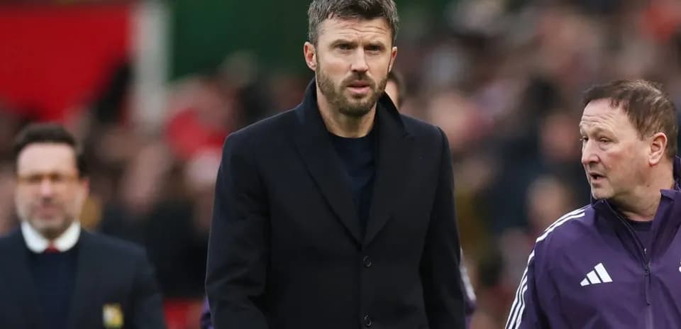 Coach walking on the pitch during match