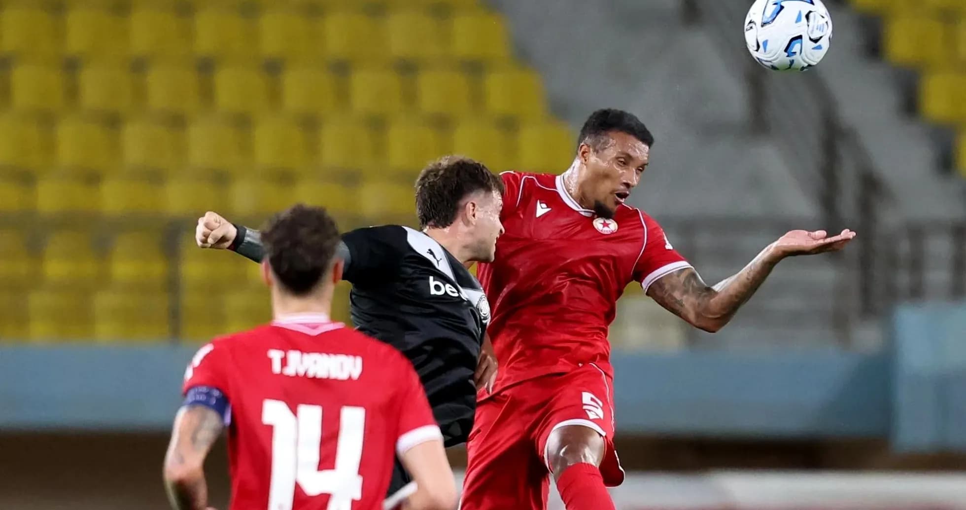 CSKA Sofia player challenging OFI player for ball