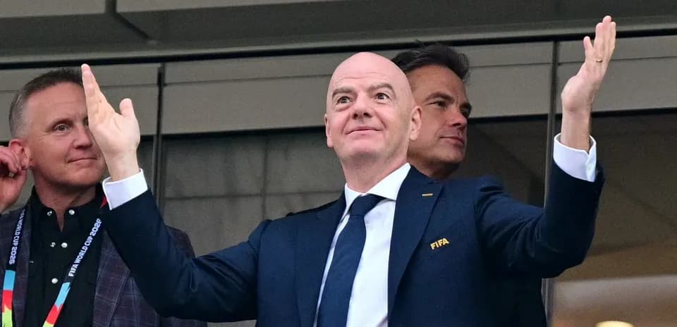 FIFA official gesturing from VIP box during event