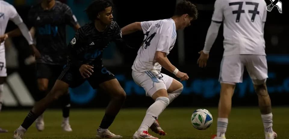 Players competing for the ball in MLS Next Pro match