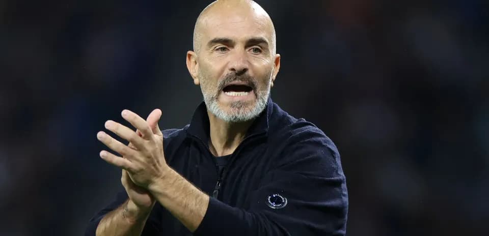 Coach gesturing and clapping during match