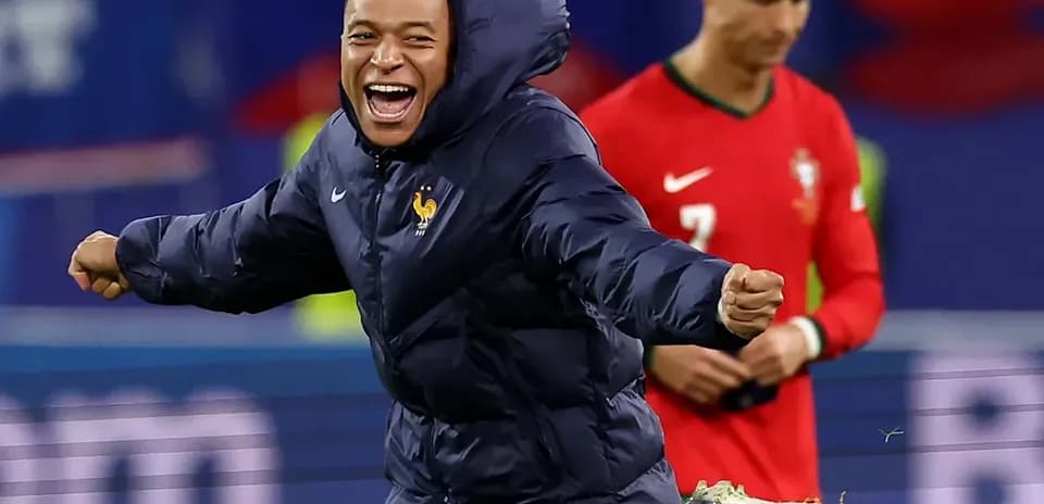Player celebrating in winter jacket on field