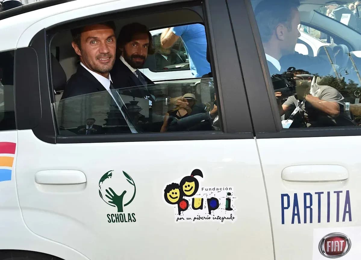 Two men in suits sitting inside a car